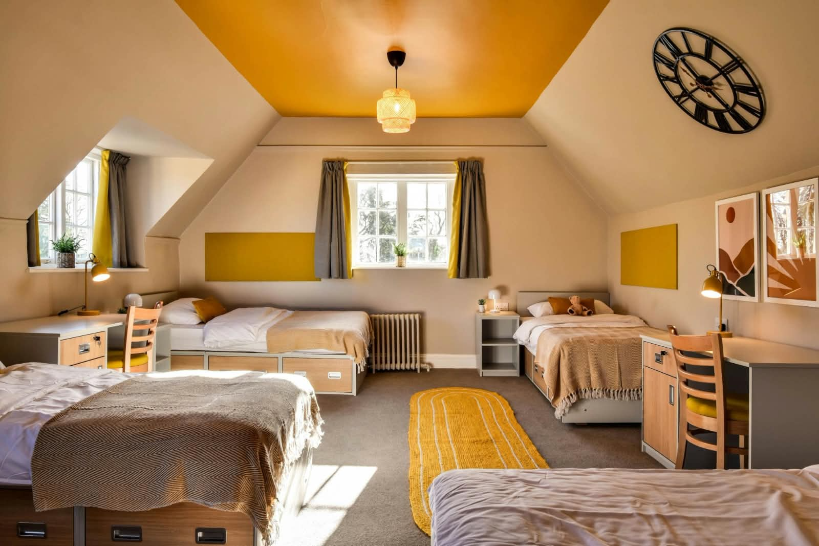 A neat boarding room with beds and study desks